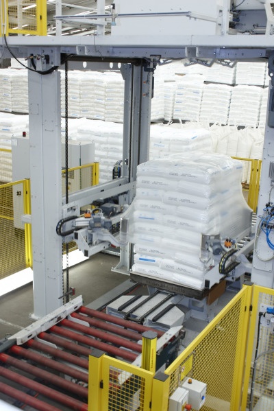 The Beumer stretch hood applies a film hood to the palletized stacks, which...