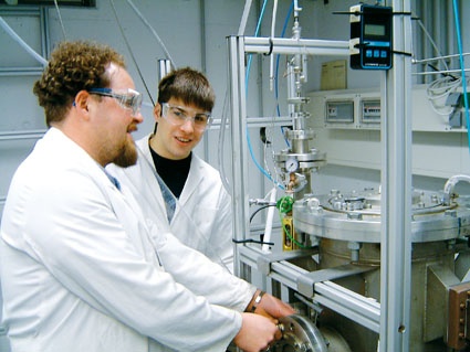 Fig. 2: Project team members at the laboratory equipment for manufacturing...