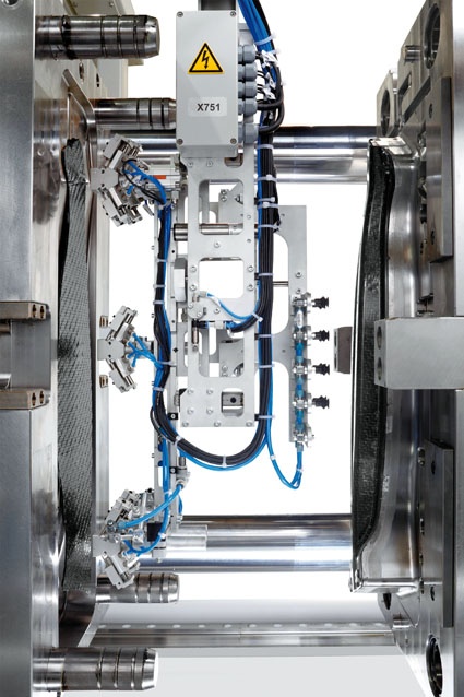 Fig. 3: Insertion of an organic sheet into an injection mould and demolding of...