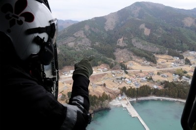 Chief Naval Air Crewman Steven Sinclair looks out from an HH-60H Sea Hawk...