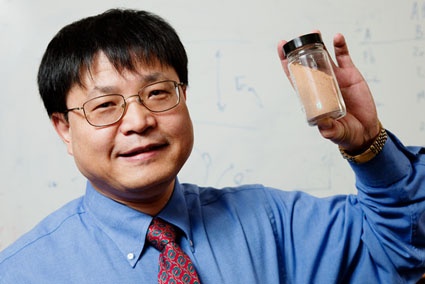 Jian Ku Shang, a professor of materials science and engineering, holds a sample...