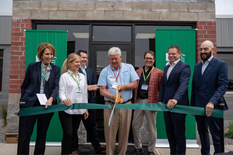 Company representatives cutting a ribbon.
