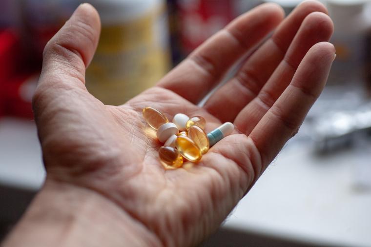 A hand holding pills