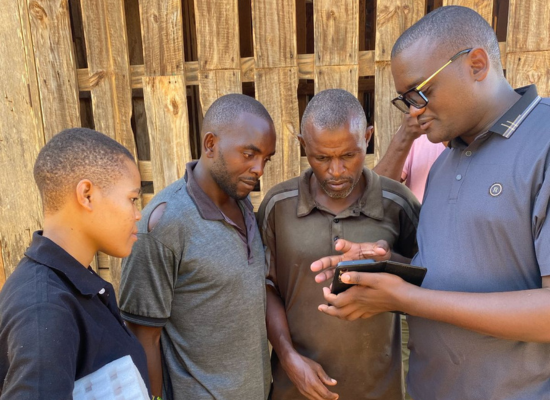 Dickson Massawe (CTO) explaining the Mnyama Check Platform to farmers,...